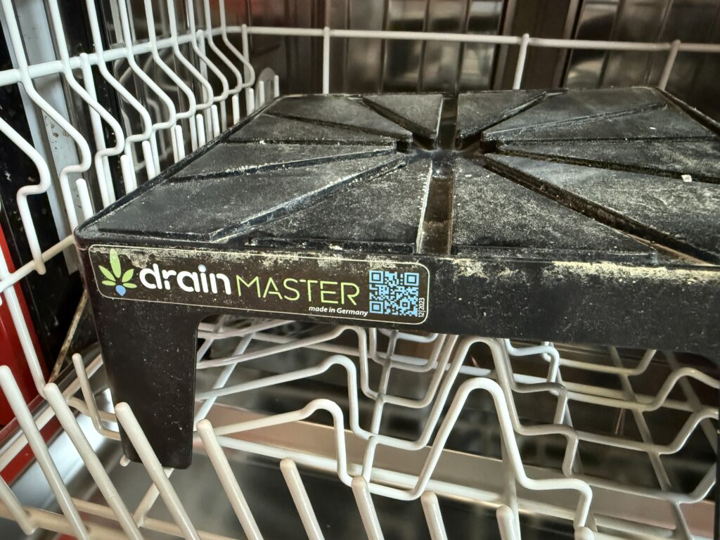 Close-up of the DrainMaster logo and the label on one leg of the Drip Stand