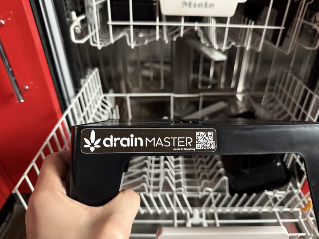 DrainMaster Drip Stand in the dishwasher, detail on the softened label